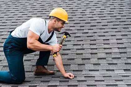 Professional roofer performing shingle repair and leak prevention on a residential home in Concord and Charlotte, NC.