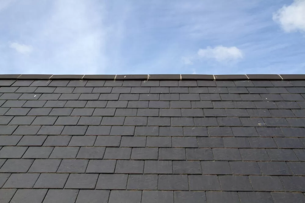 Slate roof tiles on a residential home, highlighting one of the best roofing types from Riera Moon Contractors.